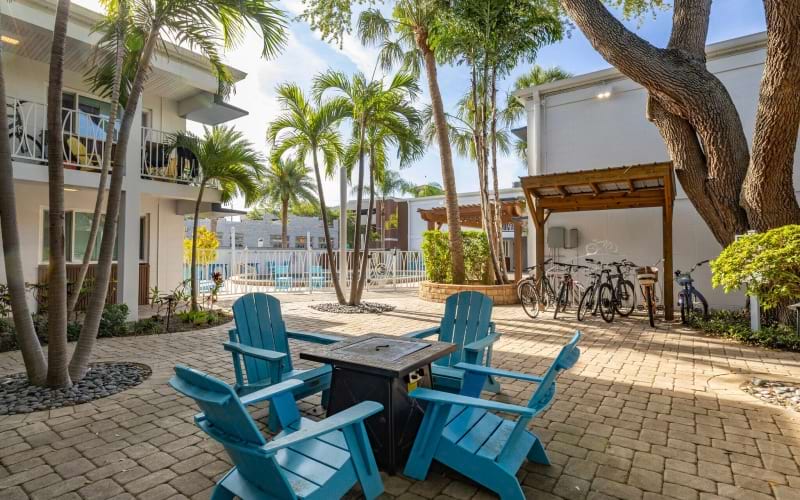 a patio with chairs and tables