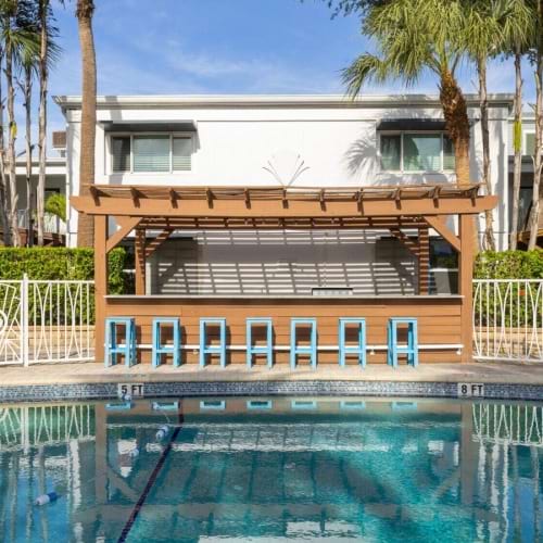 a building with a pool and trees around it